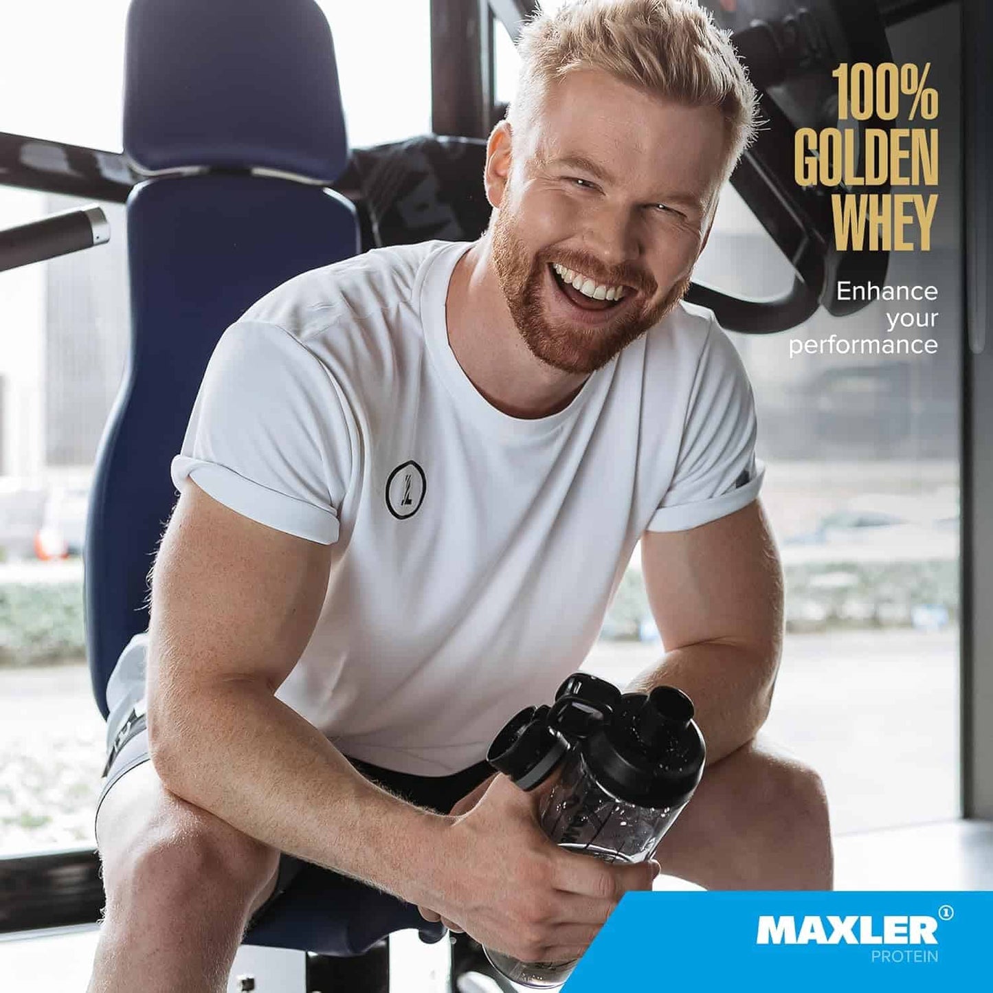 Man holding a shaker bottle in a gym setting with 'Maxler' branding.
