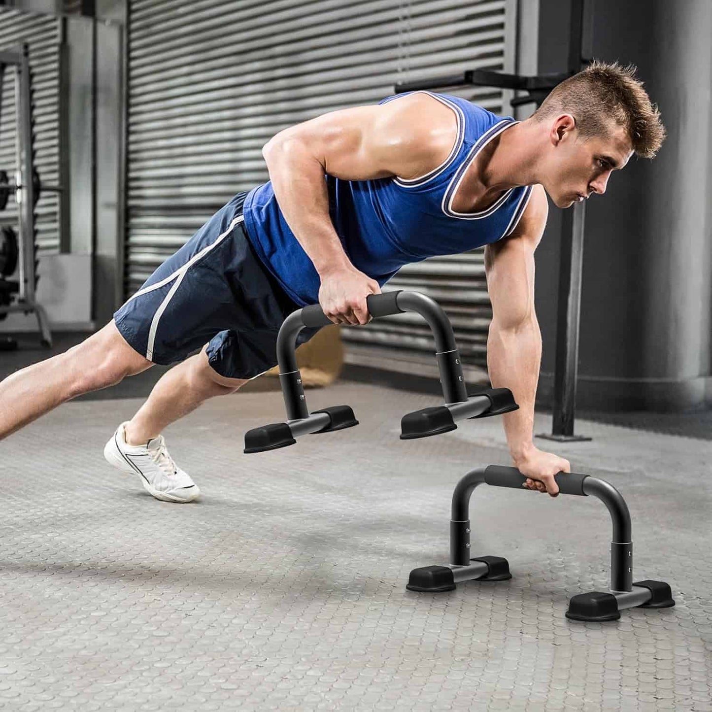 Man performing push-ups on a push-up bar in an indoor setting