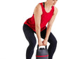 Woman in red tank top and black leggings lifting a black and red kettlebell.