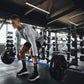 Man lifting a barbell in a gym setting