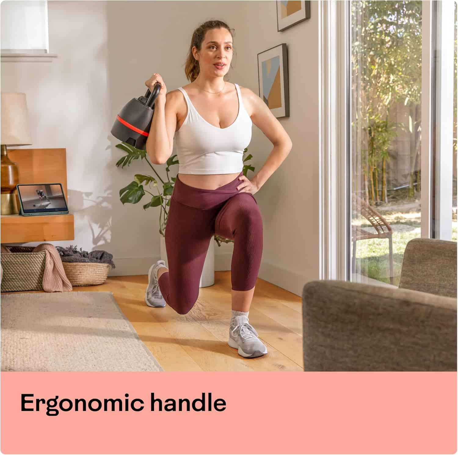 Woman exercising with a kettlebell in a home setting, emphasizing an ergonomic handle.