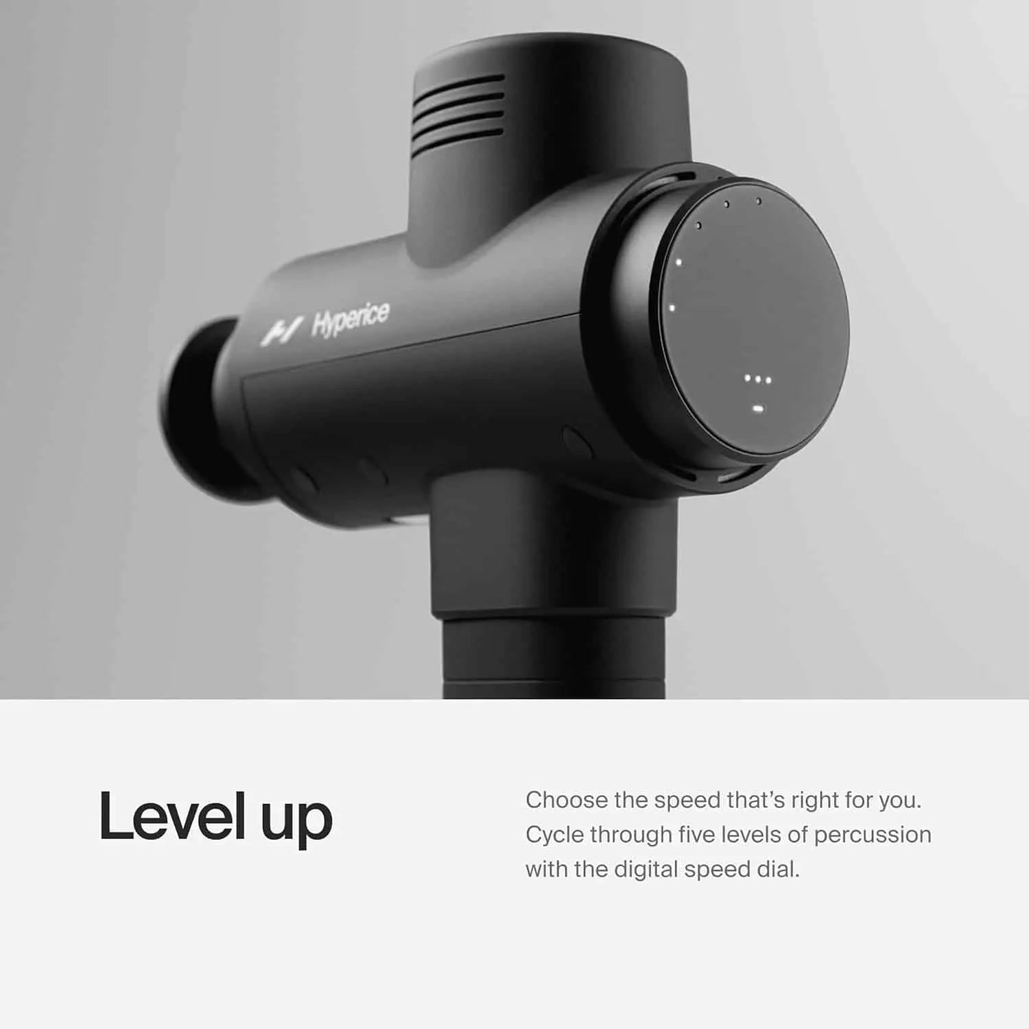 Black massage gun with digital speed dial on a gray background, featuring the brand 'Hyperice'.