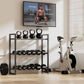 Home gym setup with kettlebells, dumbbells, and a stationary bike in front of a television displaying workout content.