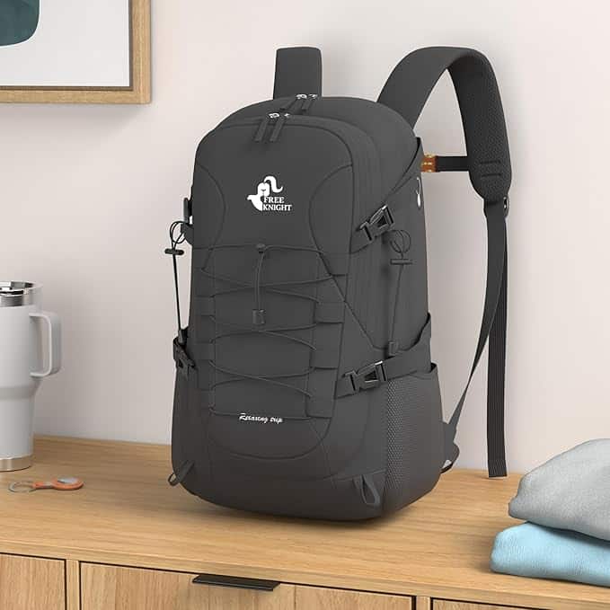 Black backpack on a wooden surface with a white background