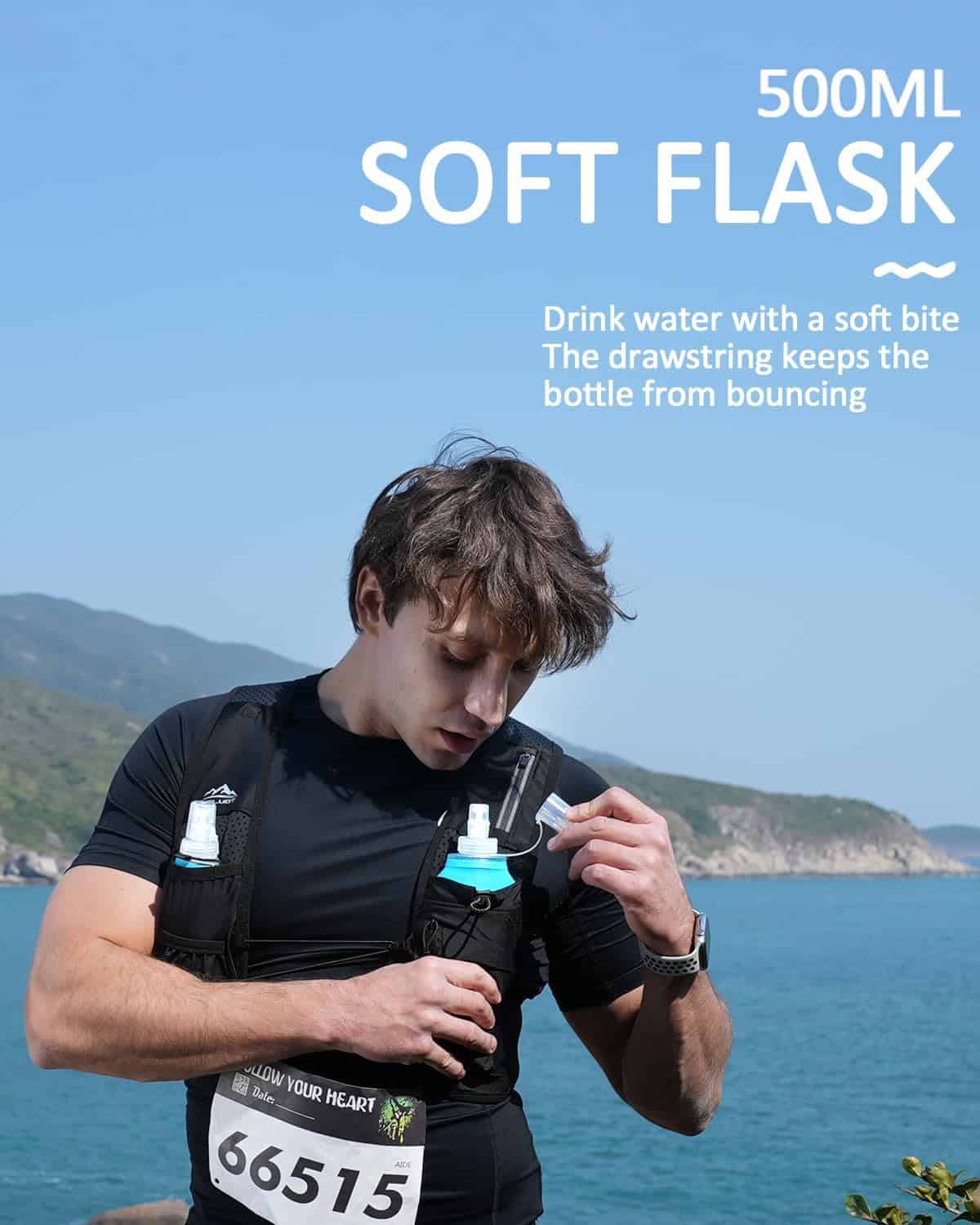 Person holding a 500ml soft flask with a scenic background