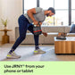 Man exercising with dumbbells in a living room using a tablet for guidance, with text promoting JRNY app.