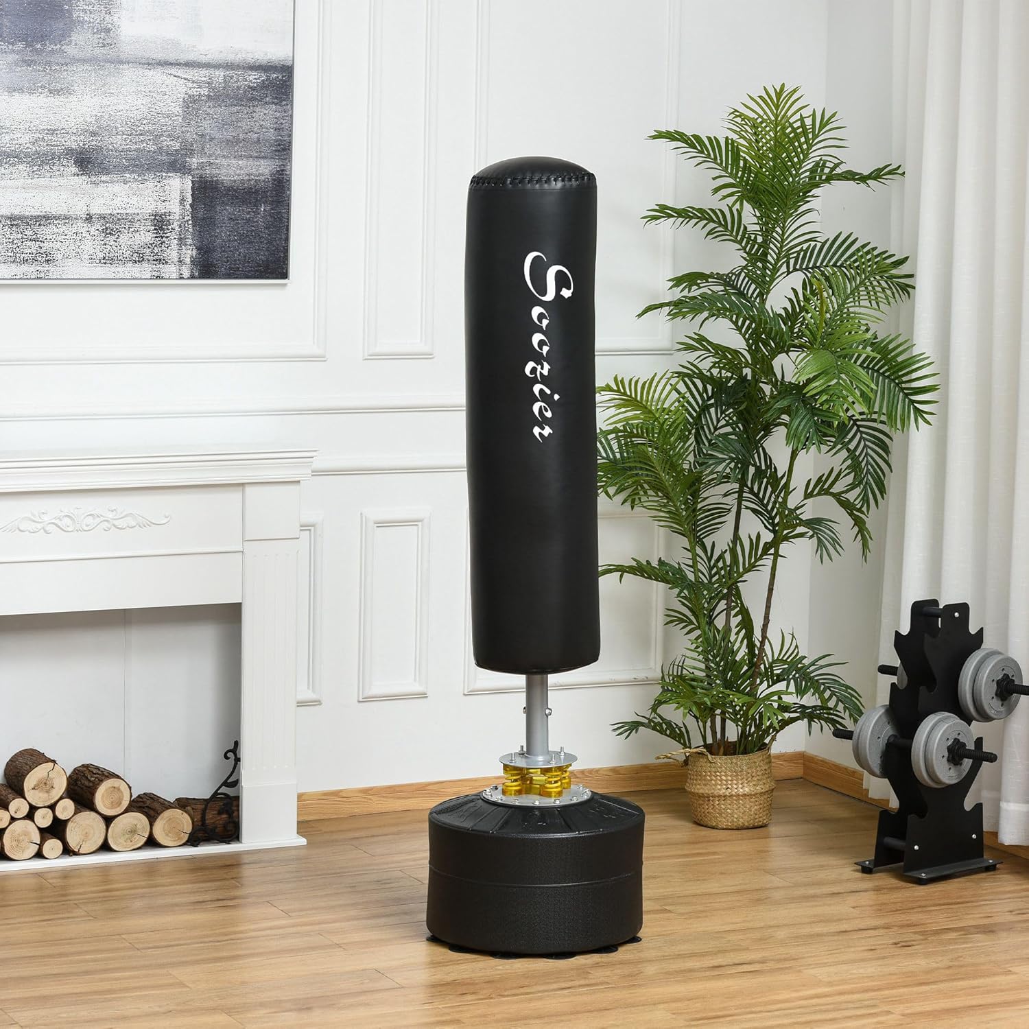 Black punching bag in a room with a fireplace and plant