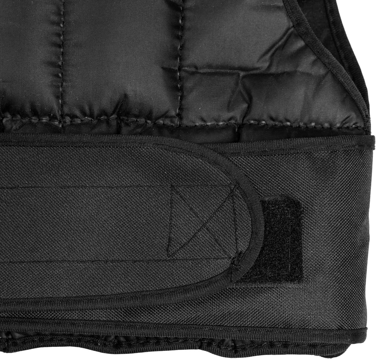 Close-up of a black quilted vest with a patch on a white background