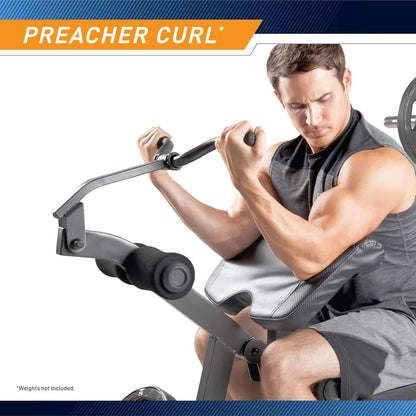 Man using a preacher curl machine in a gym setting