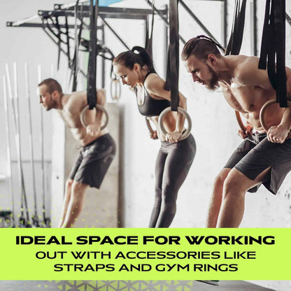 Three people exercising with straps and gym rings in a gym setting.