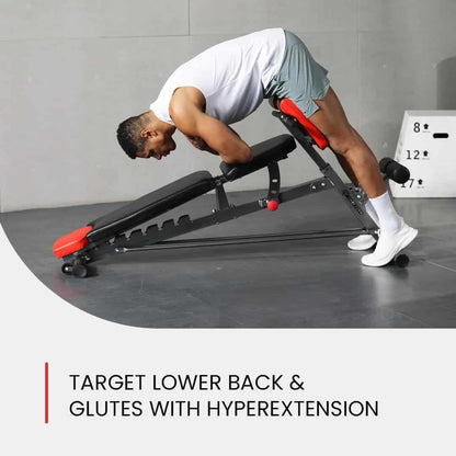 Person using a hyperextension bench for lower back and glutes exercise in a gym setting.