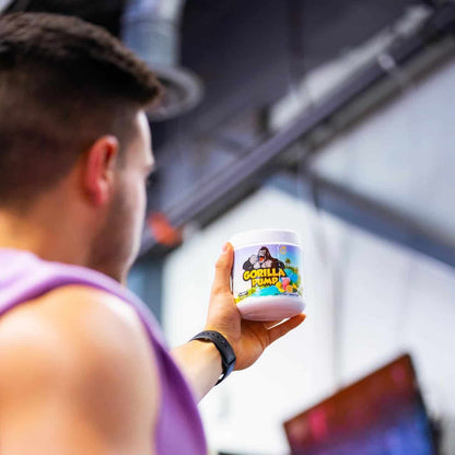 Person holding a container of Gorilla Pump supplement outdoors