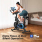 Woman exercising on a stationary bike in a living room with text about silent operation.