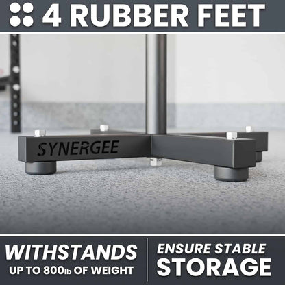 Black corner bracket with 'SYNERGEE' branding on a glass surface, featuring text about rubber feet and weight capacity.
