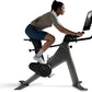 Person using a Peloton bike on a white background