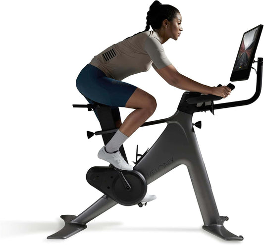 Person using a Peloton bike on a white background