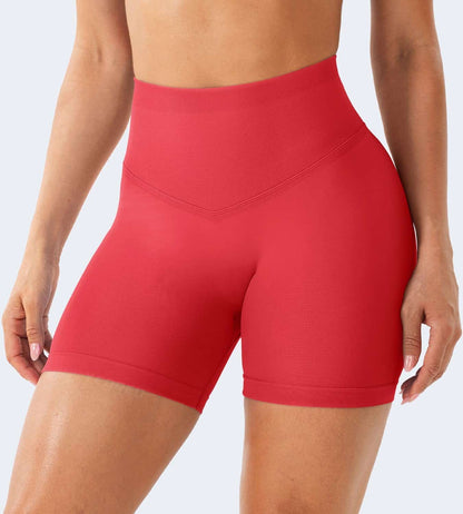 Red high-waisted shorts worn by a person on a light gray background