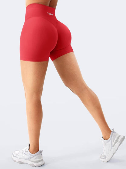 Red high-waisted shorts worn by a person on a light gray background