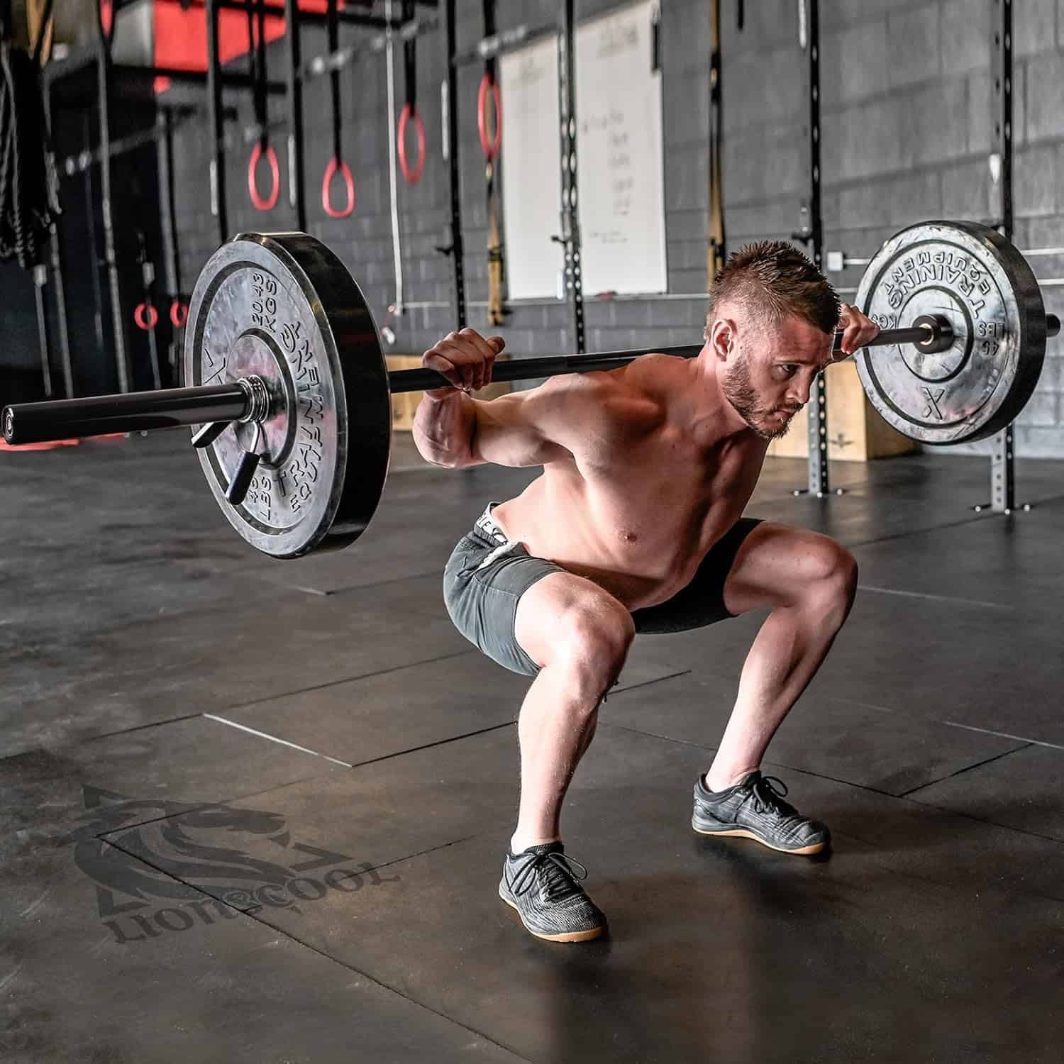Man performing a barbell squat in a gym setting
