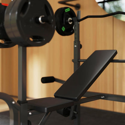 Black weight bench with barbell on a wooden background.