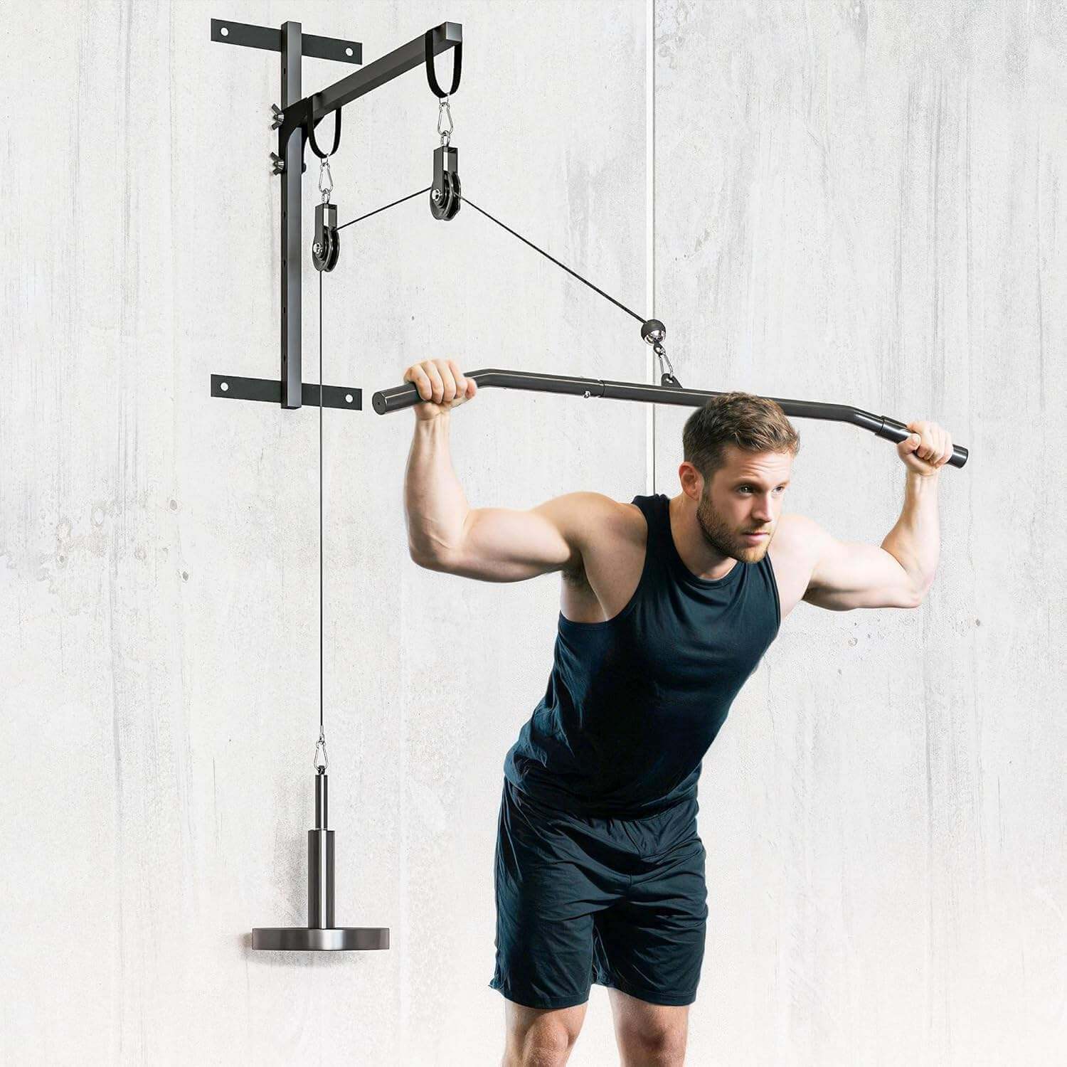 Man using a pull-up bar with weight attachments against a light gray wall.