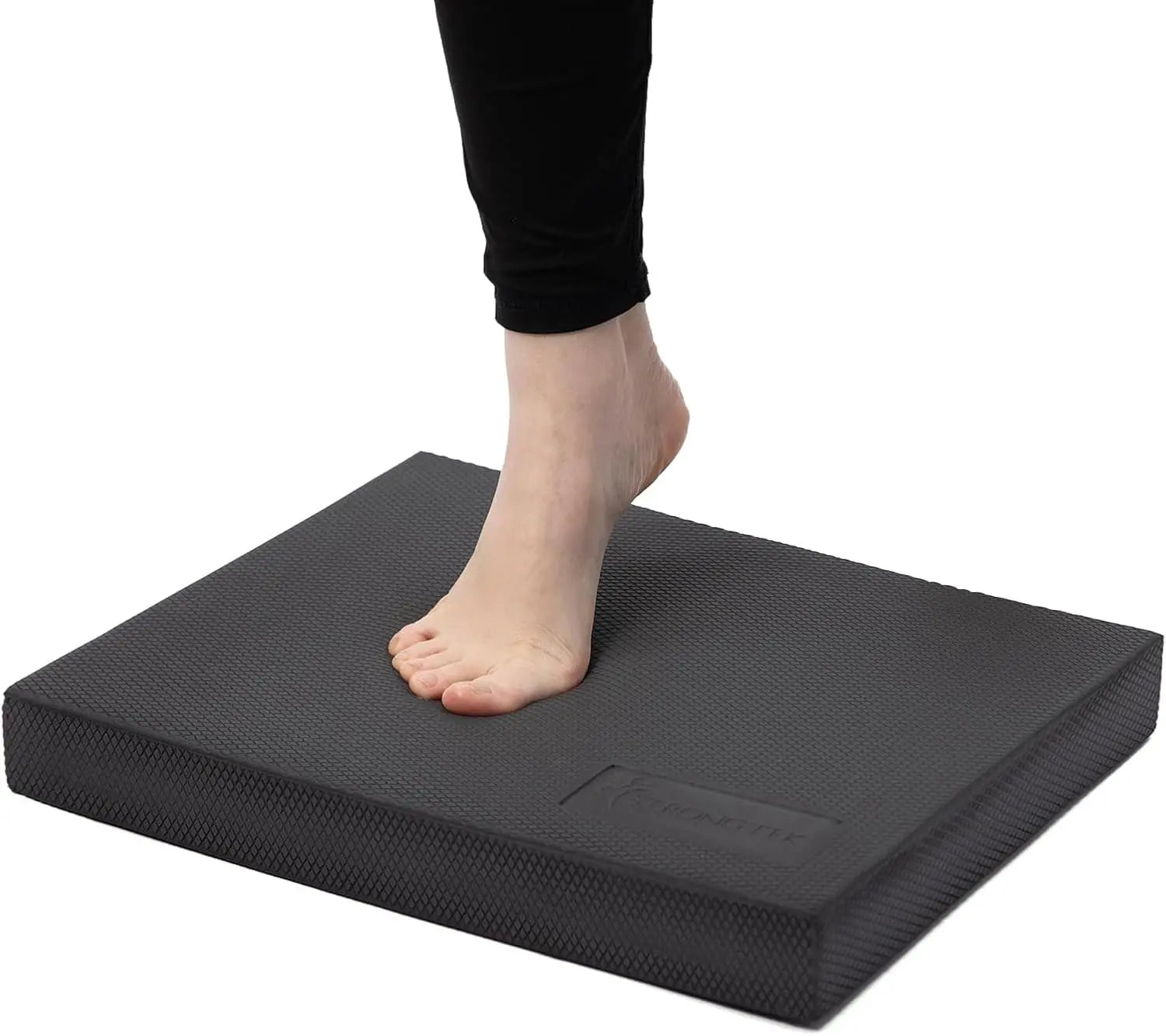 Person standing on a black footrest with a white background