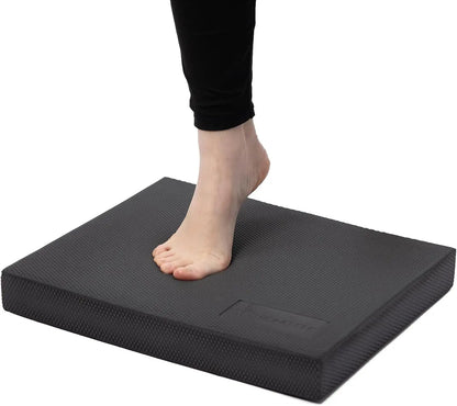 Person standing on a black footrest with a white background